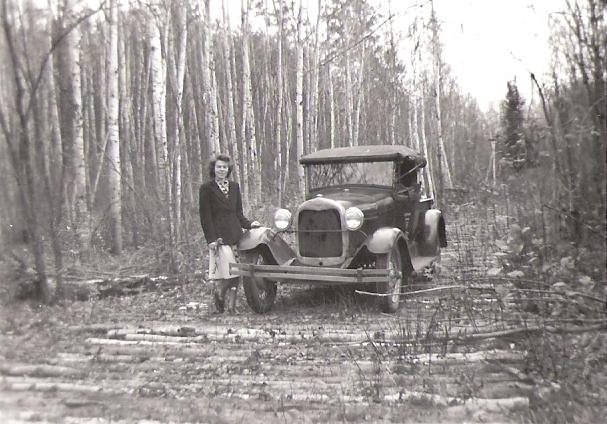 Margaret with car in woods