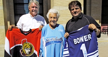 Car dealership owner Laurie Williamson, Mayor Hazel McCallion and Ron Lenyk, Publisher of The Mississauuga News, show off some of the items that will be up for auction at the golf tournament. Photo credits: Mississauga News