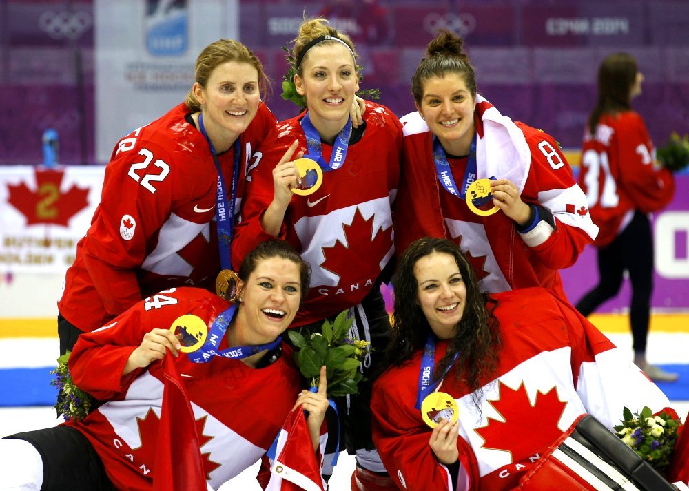 FEB 20, 2014
Canada's Wickenheiser, Agosta-Marciano, Fortino, Spooner and goalie Szabados pose with their gold medals after their team defeated Team USA in overtime in the women's gold medal ice hockey game at the 2014 Sochi Winter Olympics. Google image from http://darkroom.baltimoresun.com/wp-content/uploads/2014/02/REU-OLYMPICS-ICEHOCKEY__0016.jpg